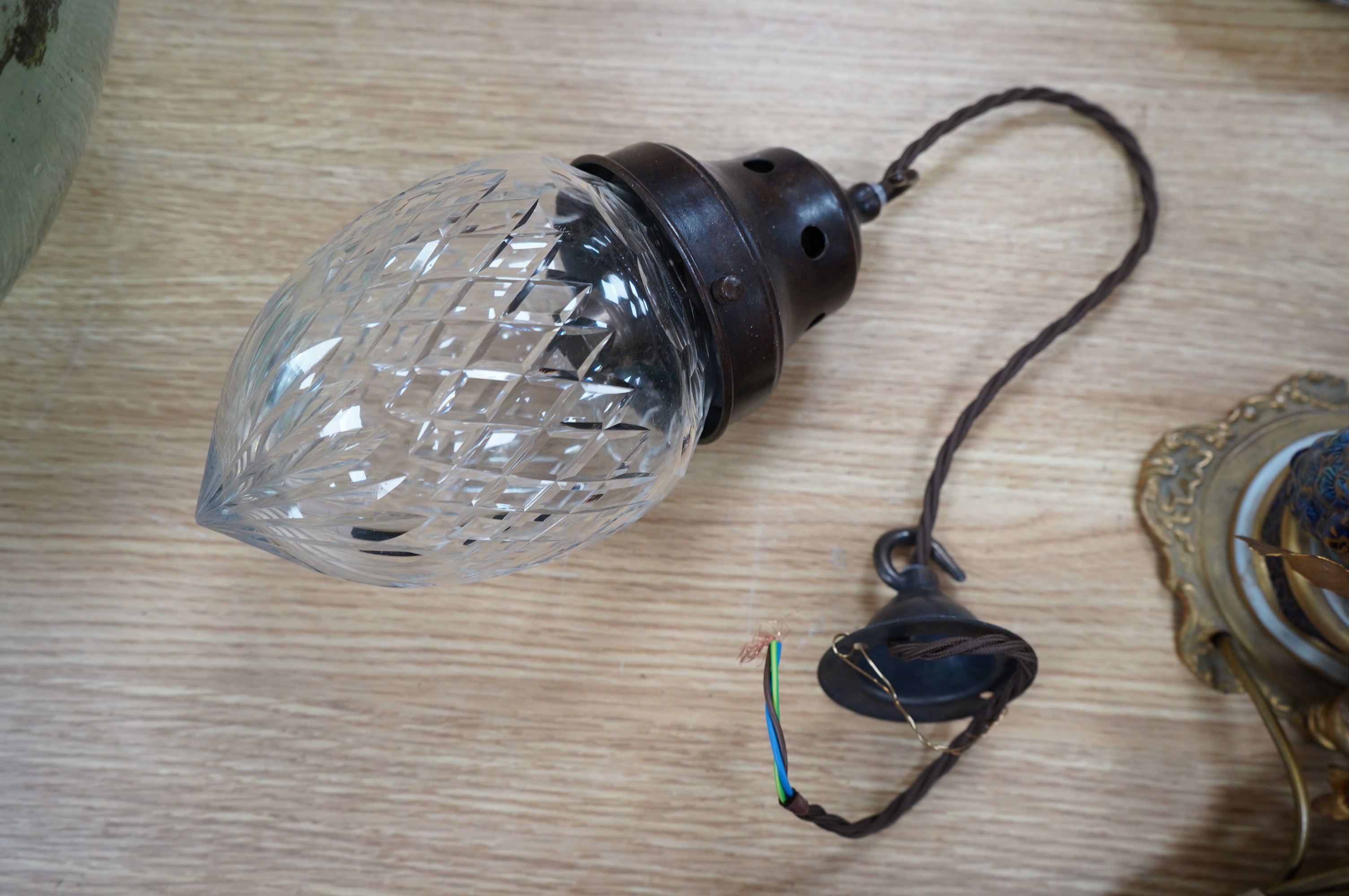 An English 1920’s crystal acorn pendant with gilded bronzed fitting, chain and ceiling rose, wired, glass including gallery 24cm high, 11cm across. Condition - good.